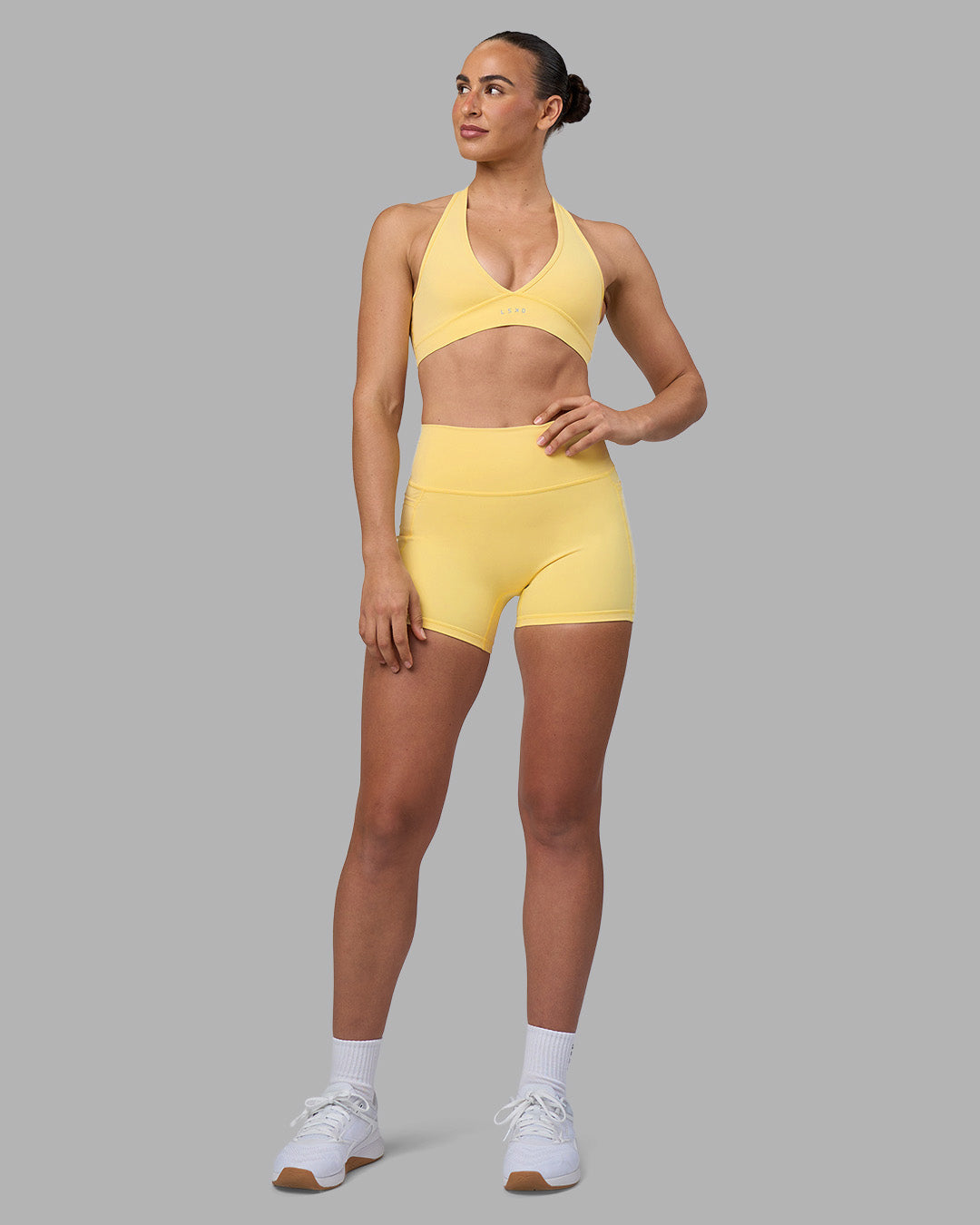 Woman wearing Fusion Ultra High-Rise 4" Short Pockets - Lemon | Model:Sophie | Size:S