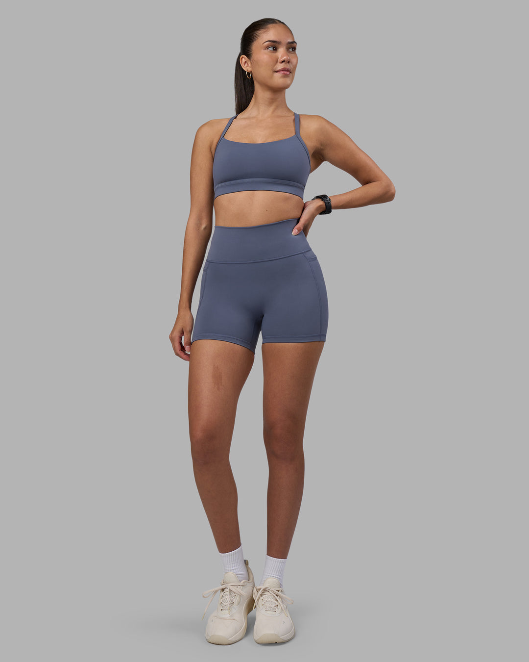 Woman wearing Fusion Ultra High-Rise 4" Short Pockets - Night Shadow | Model:Rhiley | Size:S