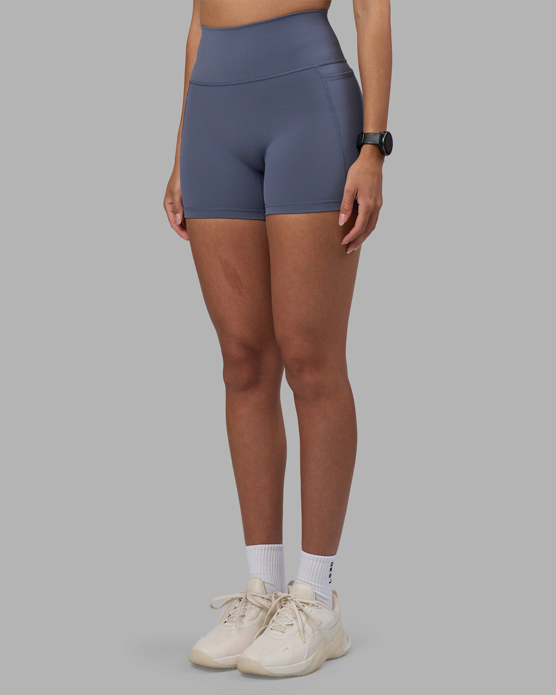 Woman wearing Fusion Ultra High-Rise 4" Short Pockets - Night Shadow | Model:Rhiley | Size:S