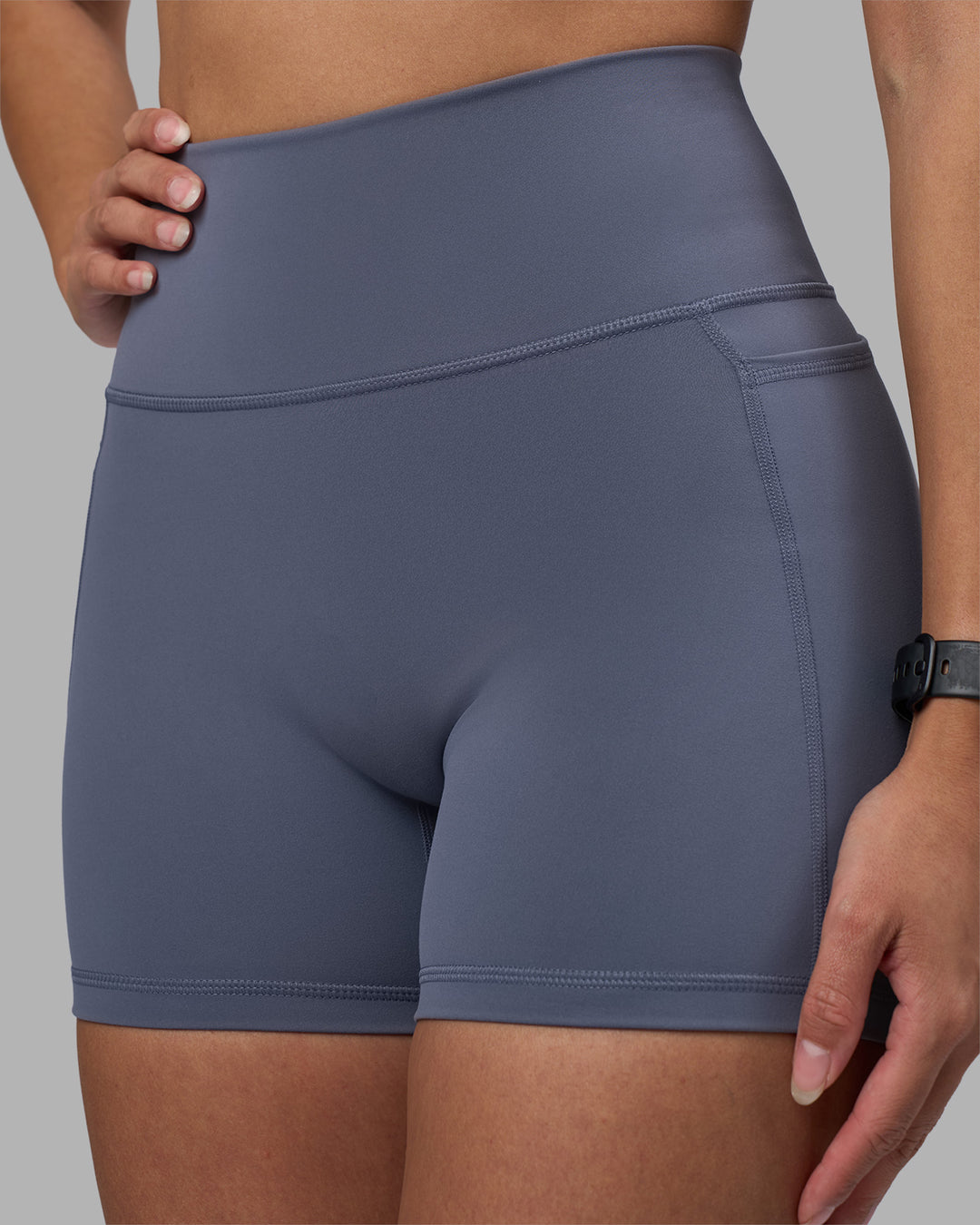 Woman wearing Fusion Ultra High-Rise 4" Short Pockets - Night Shadow | Model:Rhiley | Size:S