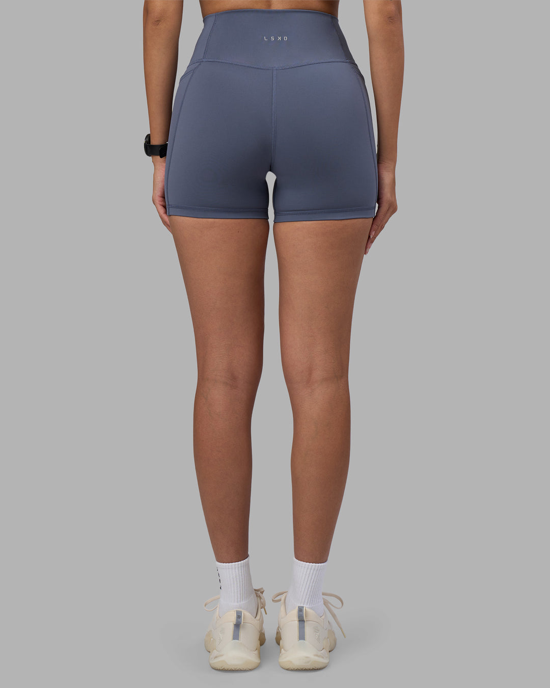 Woman wearing Fusion Ultra High-Rise 4" Short Pockets - Night Shadow | Model:Rhiley | Size:S