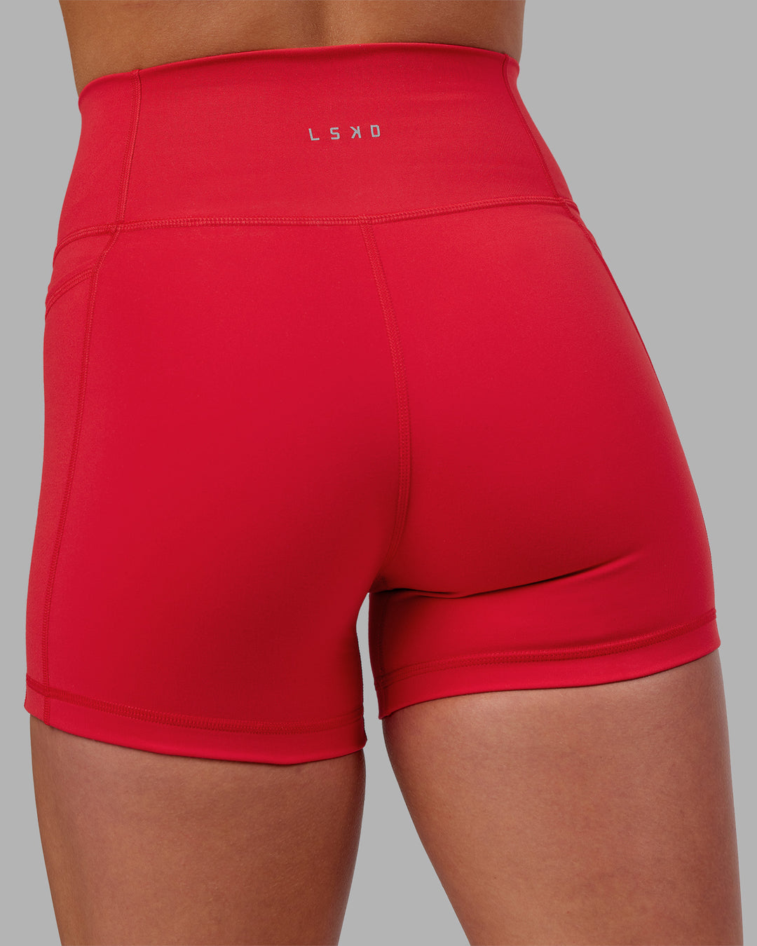 Woman wearing Fusion Ultra High-Rise 4" Short Pockets - Scarlet | Model:Keisha | Size:S