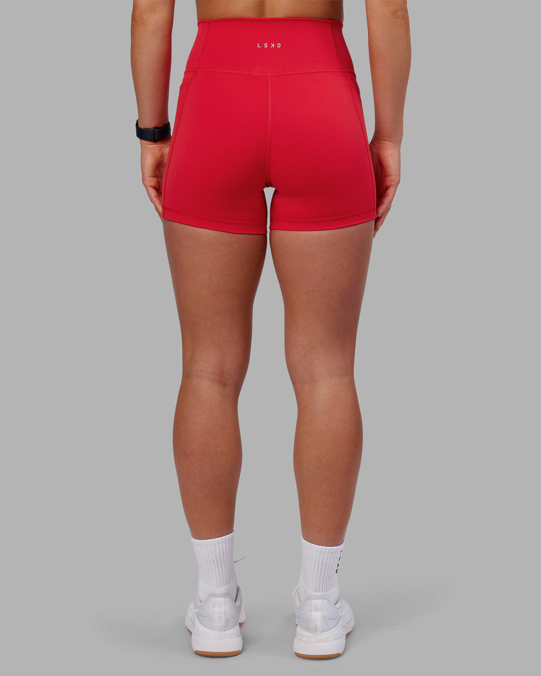 Woman wearing Fusion Ultra High-Rise 4" Short Pockets - Scarlet | Model:Keisha | Size:S