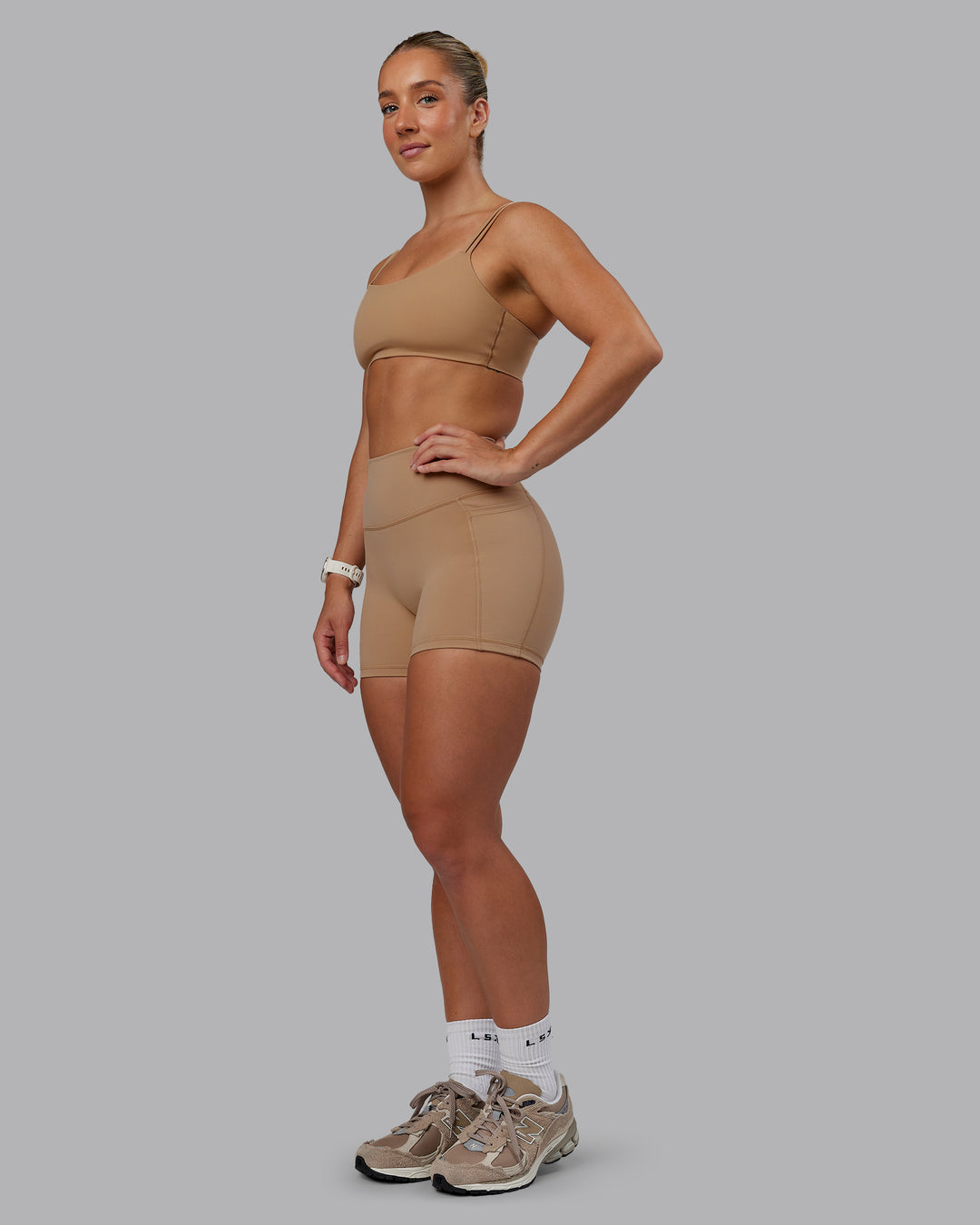 Woman wearing Fusion Ultra High-Rise 4" Short Pockets - Warm Smoke | Model:Lyss | Size:S