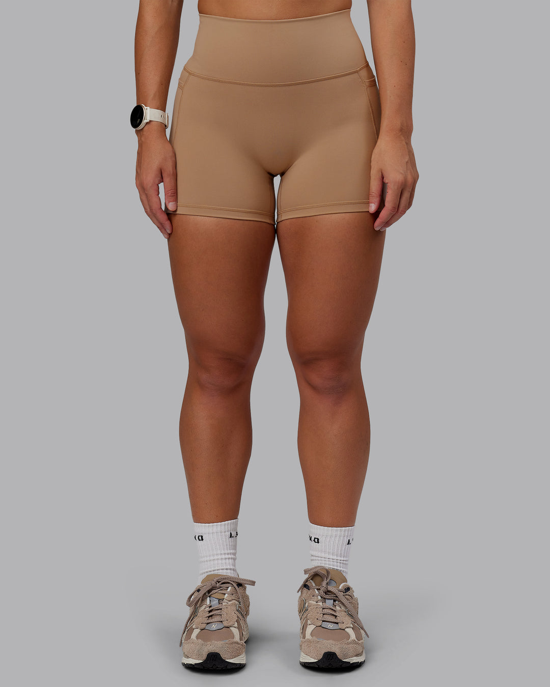Woman wearing Fusion Ultra High-Rise 4" Short Pockets - Warm Smoke | Model:Lyss | Size:S