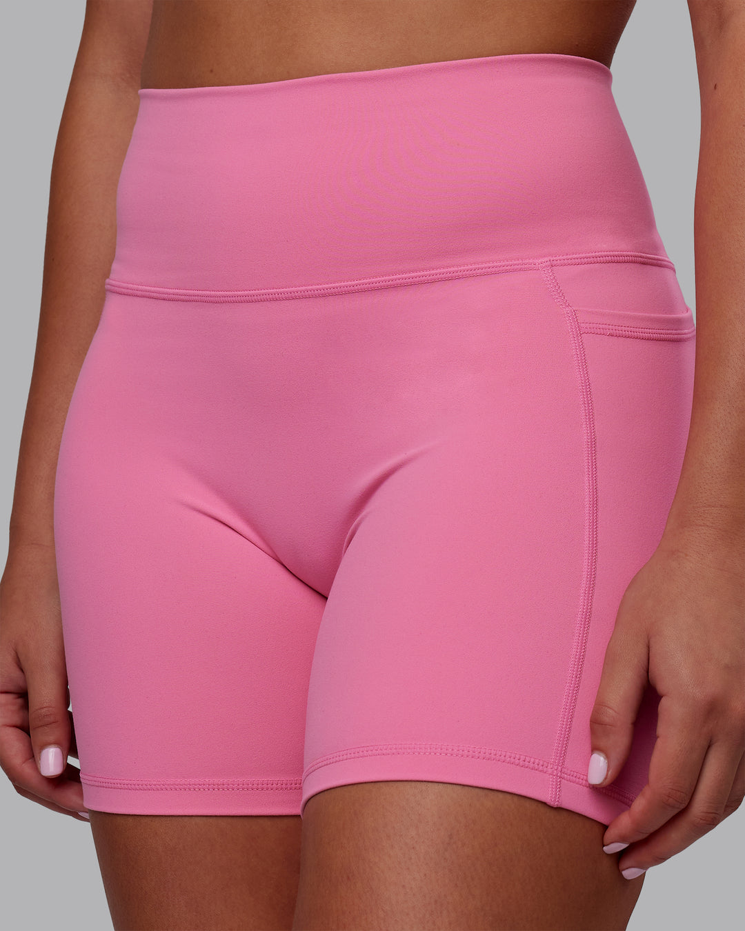 Woman wearing Fusion Ultra High-Rise 6" Short Pockets - Candy Pink | Model:Charlize | Size:S