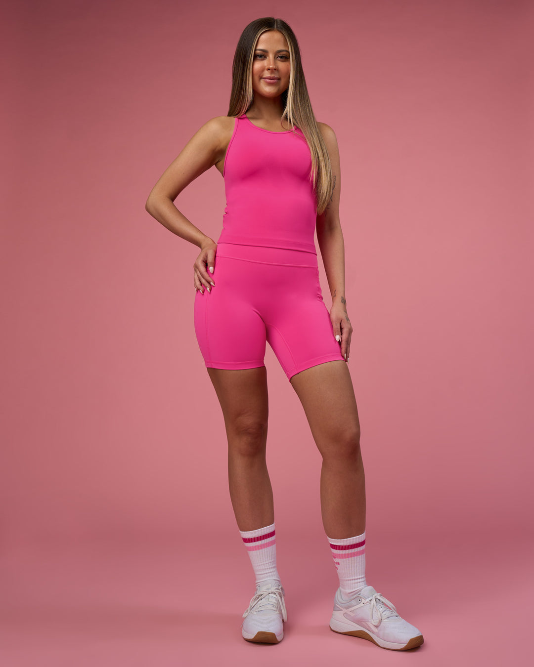 Woman wearing Fusion Ultra High-Rise 6" Short Pockets - Ultra Pink | Model:Tianah | Size:S