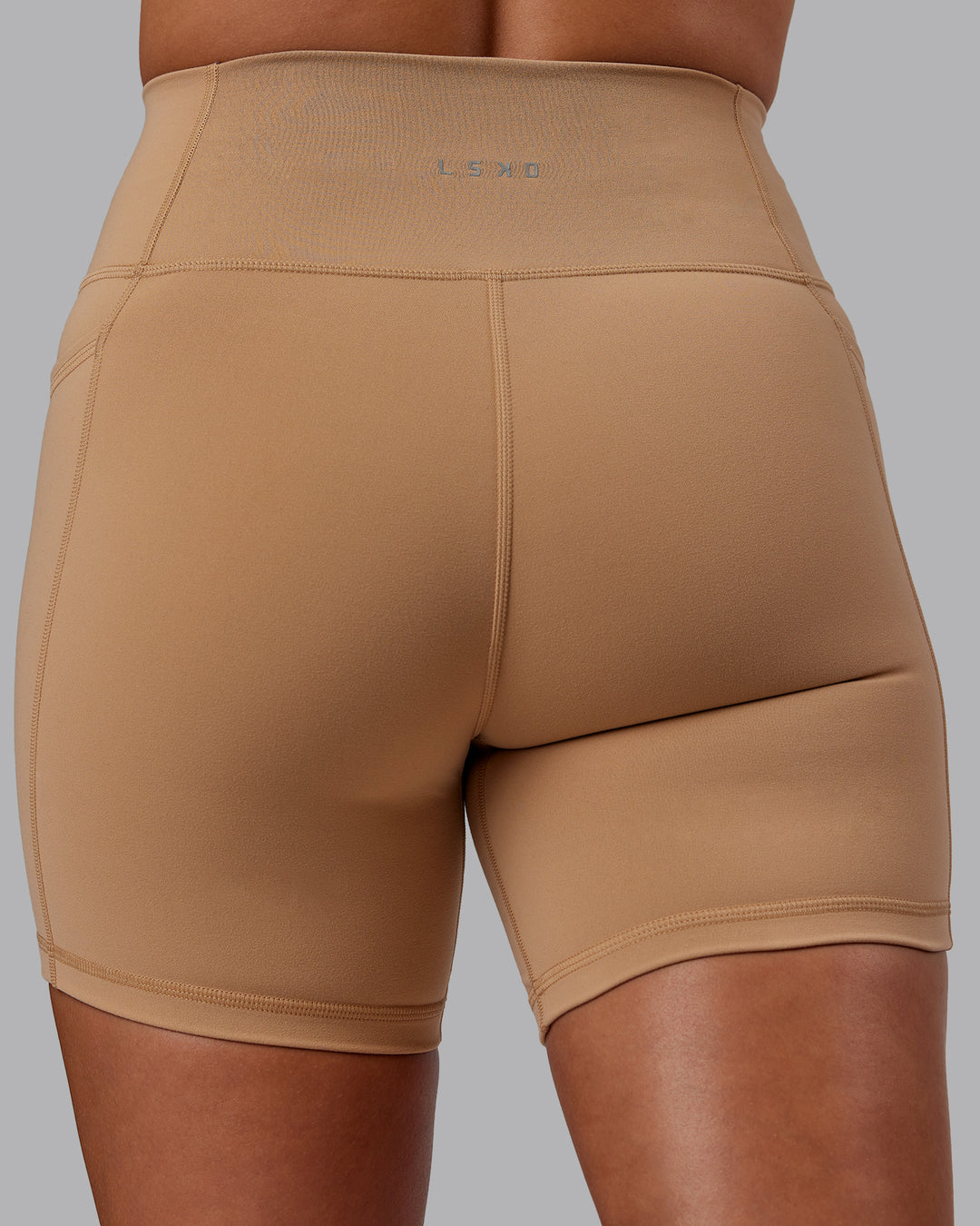 Woman wearing Fusion Ultra High-Rise 6" Short Pockets - Warm Smoke | Model:Phoebe | Size:S