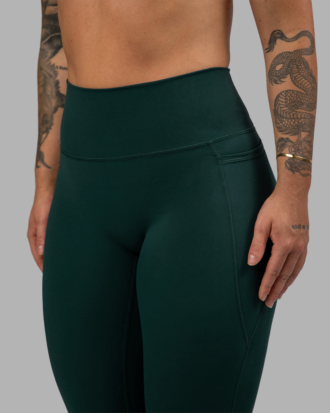 Woman wearing Fusion Ultra High-Rise Full Length Legging Pockets - Dark Moss | Model:Robyn | Size:S