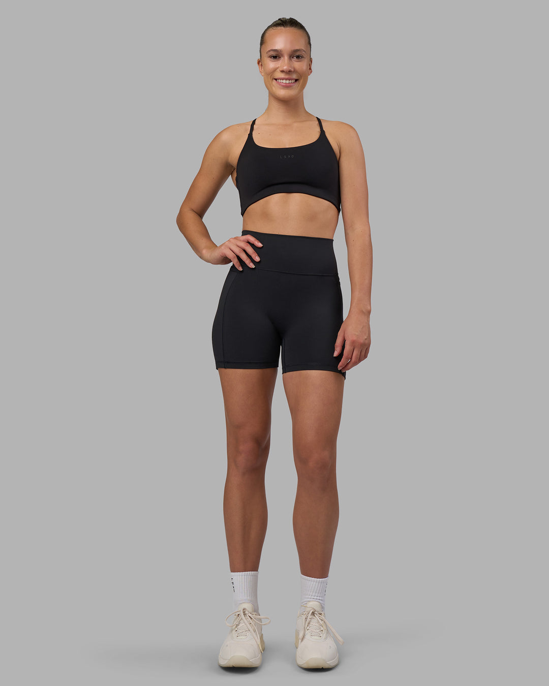 Woman wearing Fusion V-Contour Ultra High-Rise 4โ Short Pockets - Black | Model:Charlize | Size:S