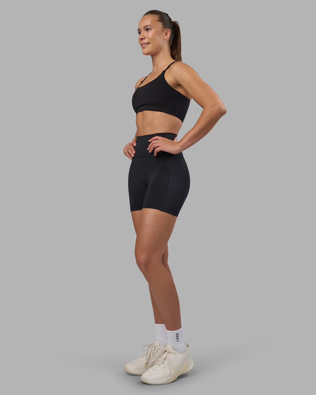 Woman wearing Fusion V-Contour Ultra High-Rise 4โ Short Pockets - Black | Model:Charlize | Size:S