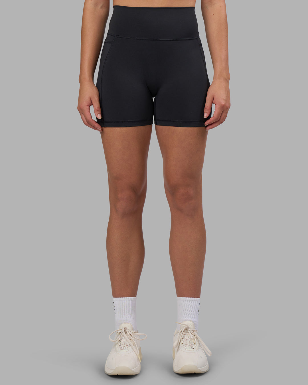 Woman wearing Fusion V-Contour Ultra High-Rise 4โ Short Pockets - Black | Model:Charlize | Size:S