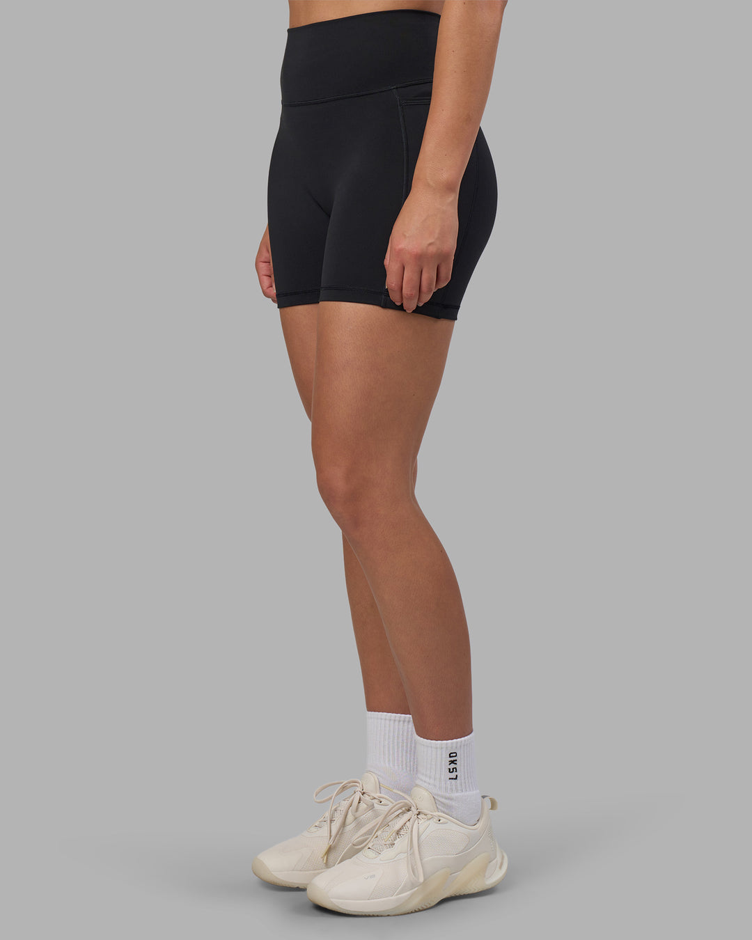 Woman wearing Fusion V-Contour Ultra High-Rise 4โ Short Pockets - Black | Model:Charlize | Size:S