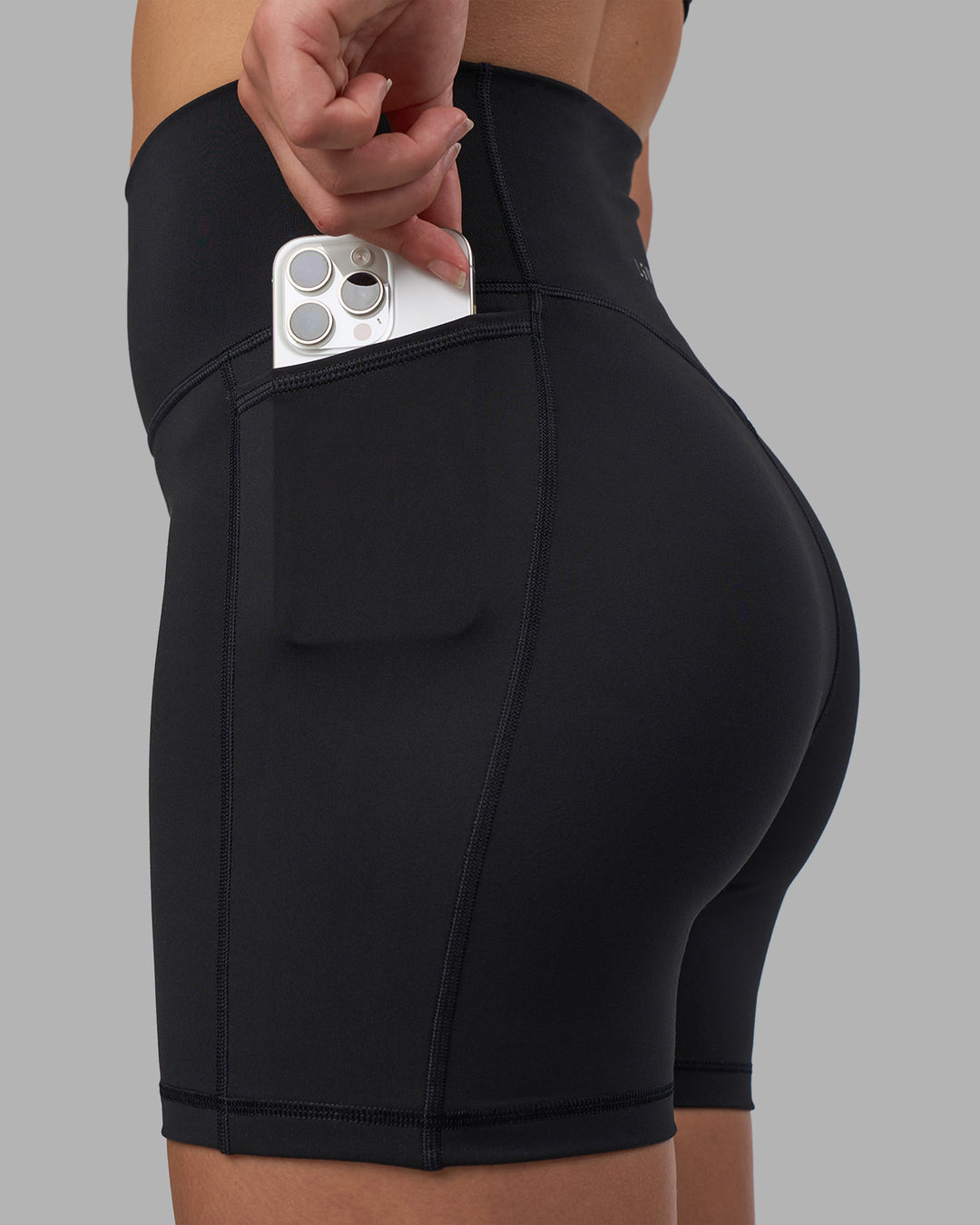 Woman wearing Fusion V-Contour Ultra High-Rise 4โ Short Pockets - Black | Model:Charlize | Size:S