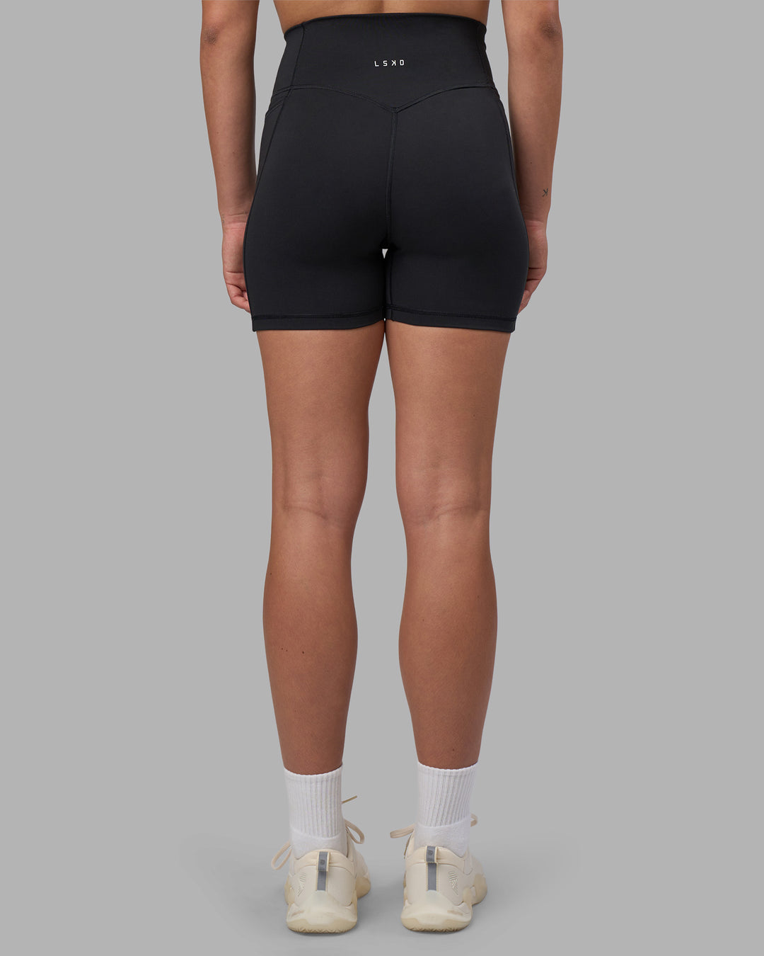 Woman wearing Fusion V-Contour Ultra High-Rise 4โ Short Pockets - Black | Model:Charlize | Size:S