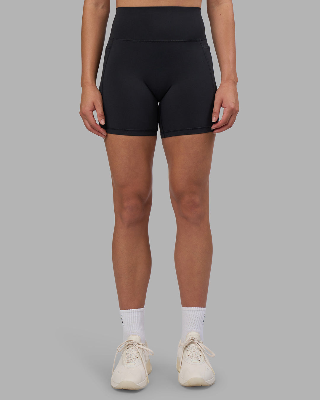 Woman wearing Fusion V-Contour Ultra High-Rise 6" Short Pockets - Black | Model:Charlize | Size:S