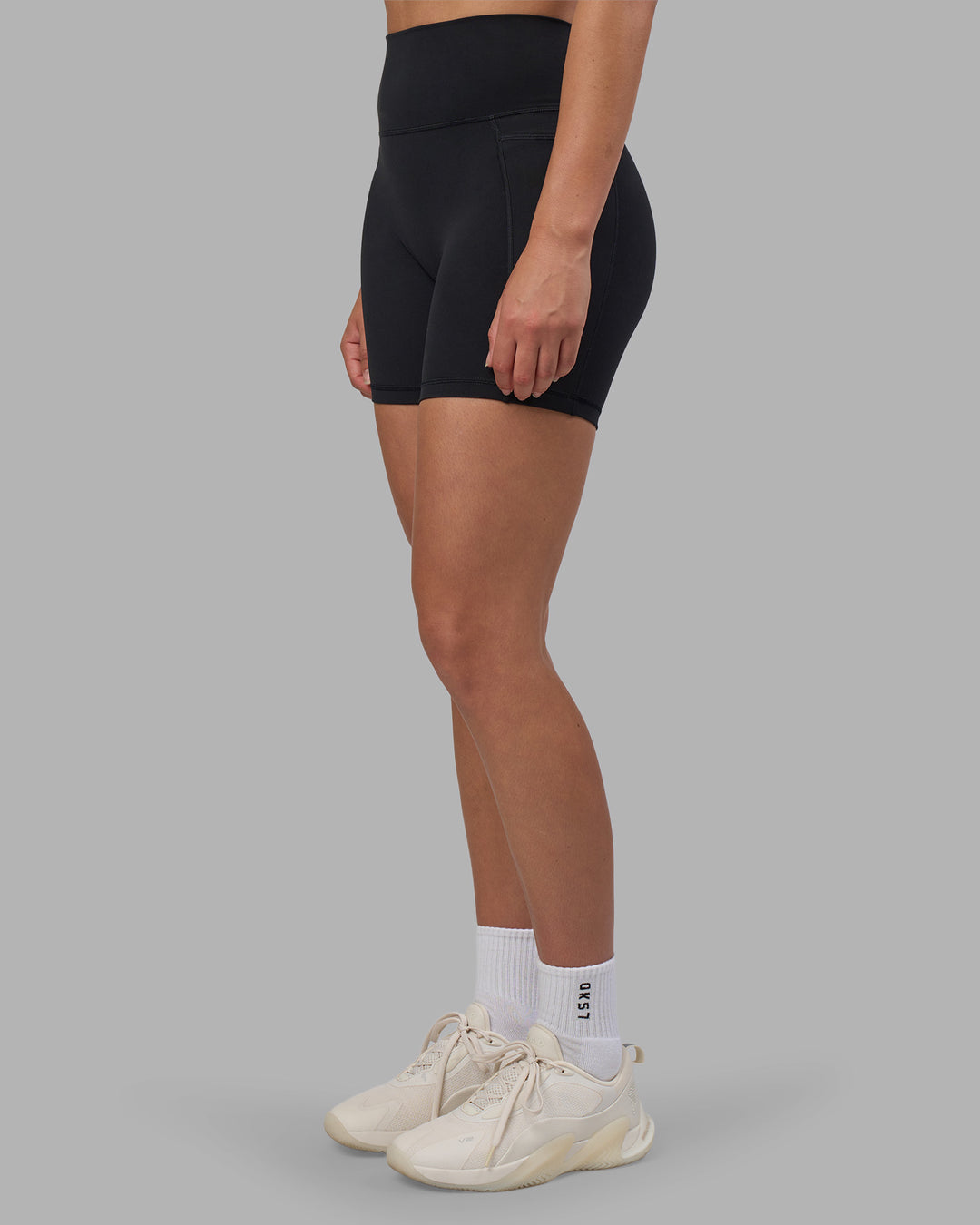 Woman wearing Fusion V-Contour Ultra High-Rise 6" Short Pockets - Black | Model:Charlize | Size:S