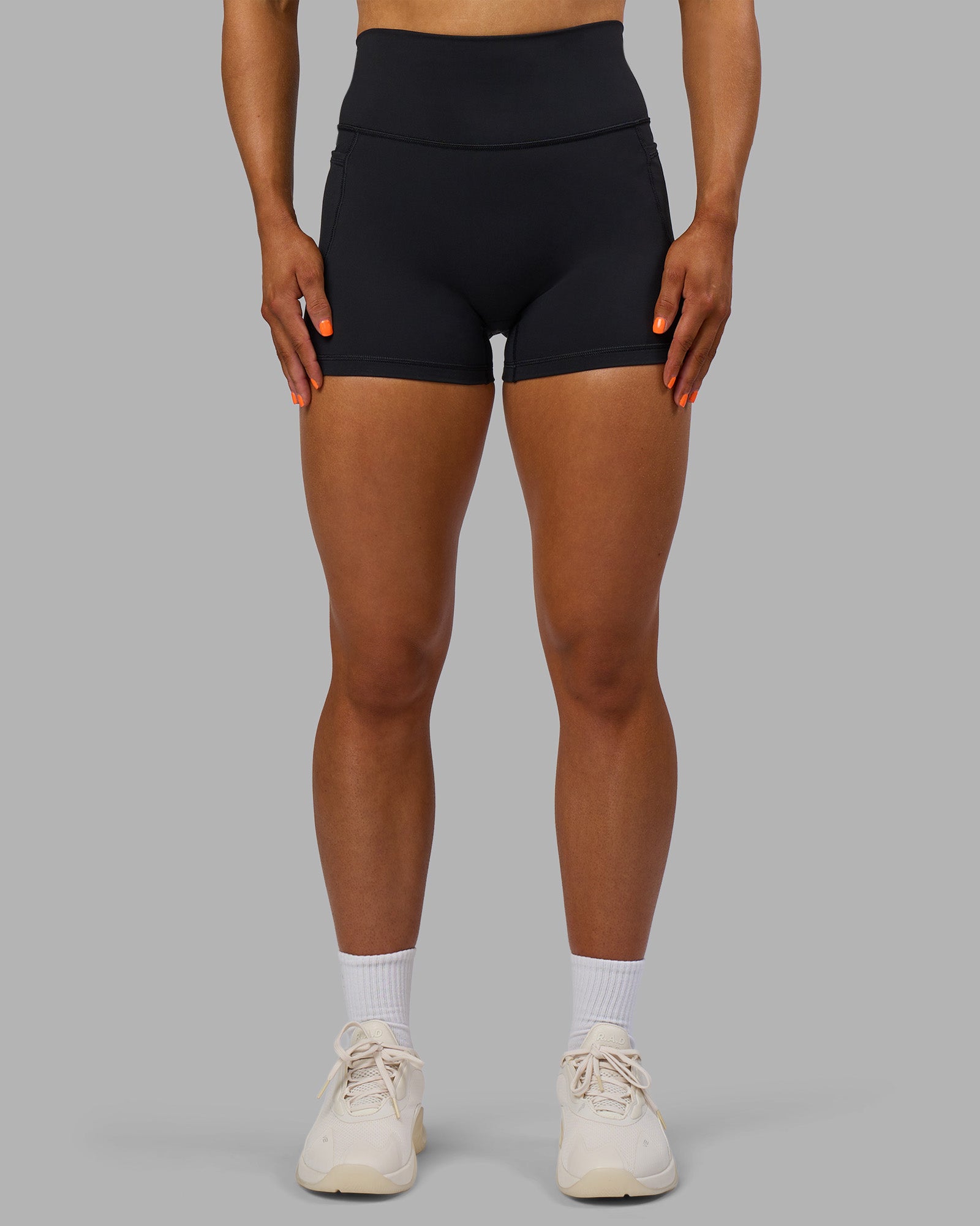 Woman wearing Fusion Ultra High-Rise 4" Short Pockets - Black | Model:Georgia | Size:S