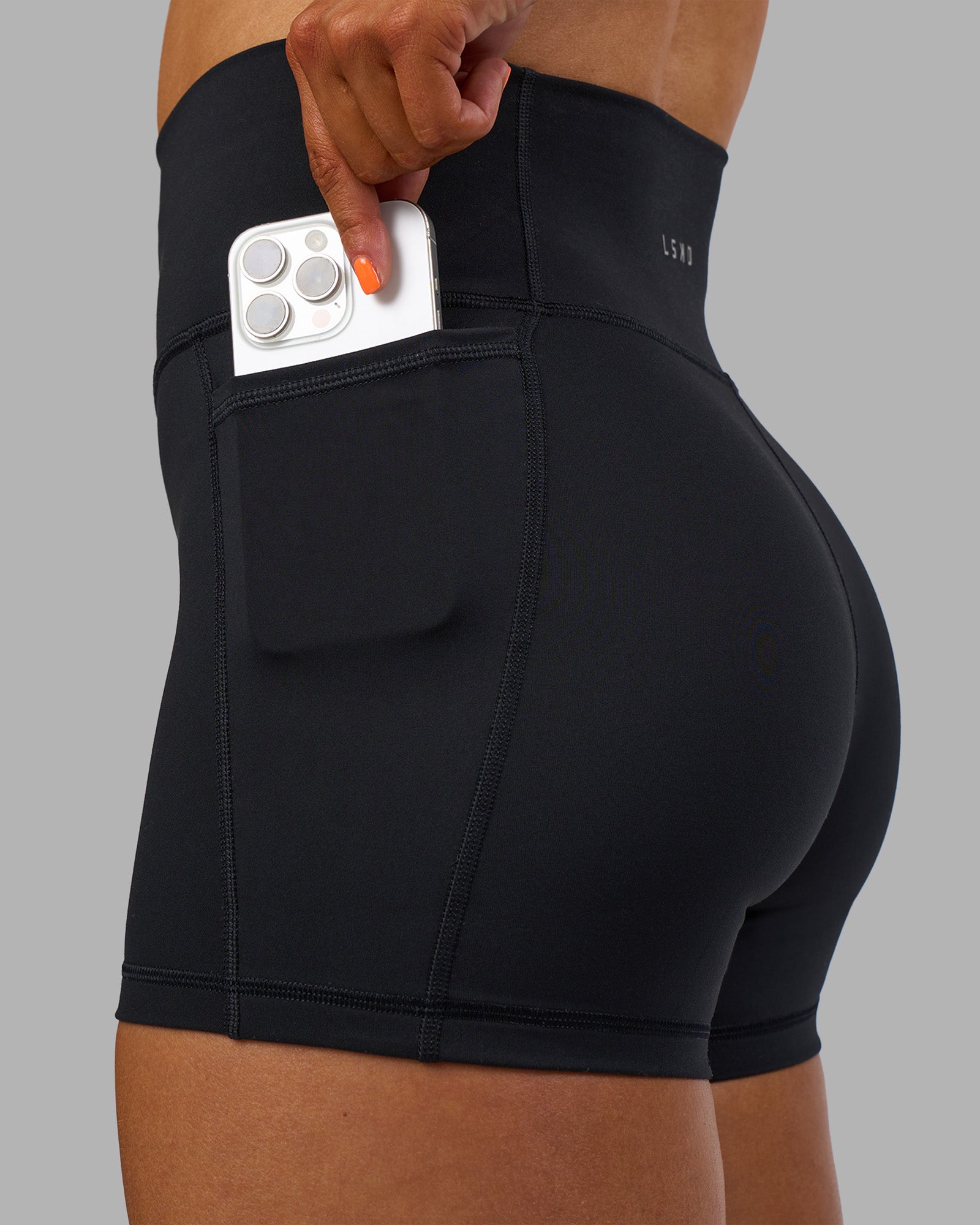 Woman wearing Fusion Ultra High-Rise 4" Short Pockets - Black | Model:Georgia | Size:S