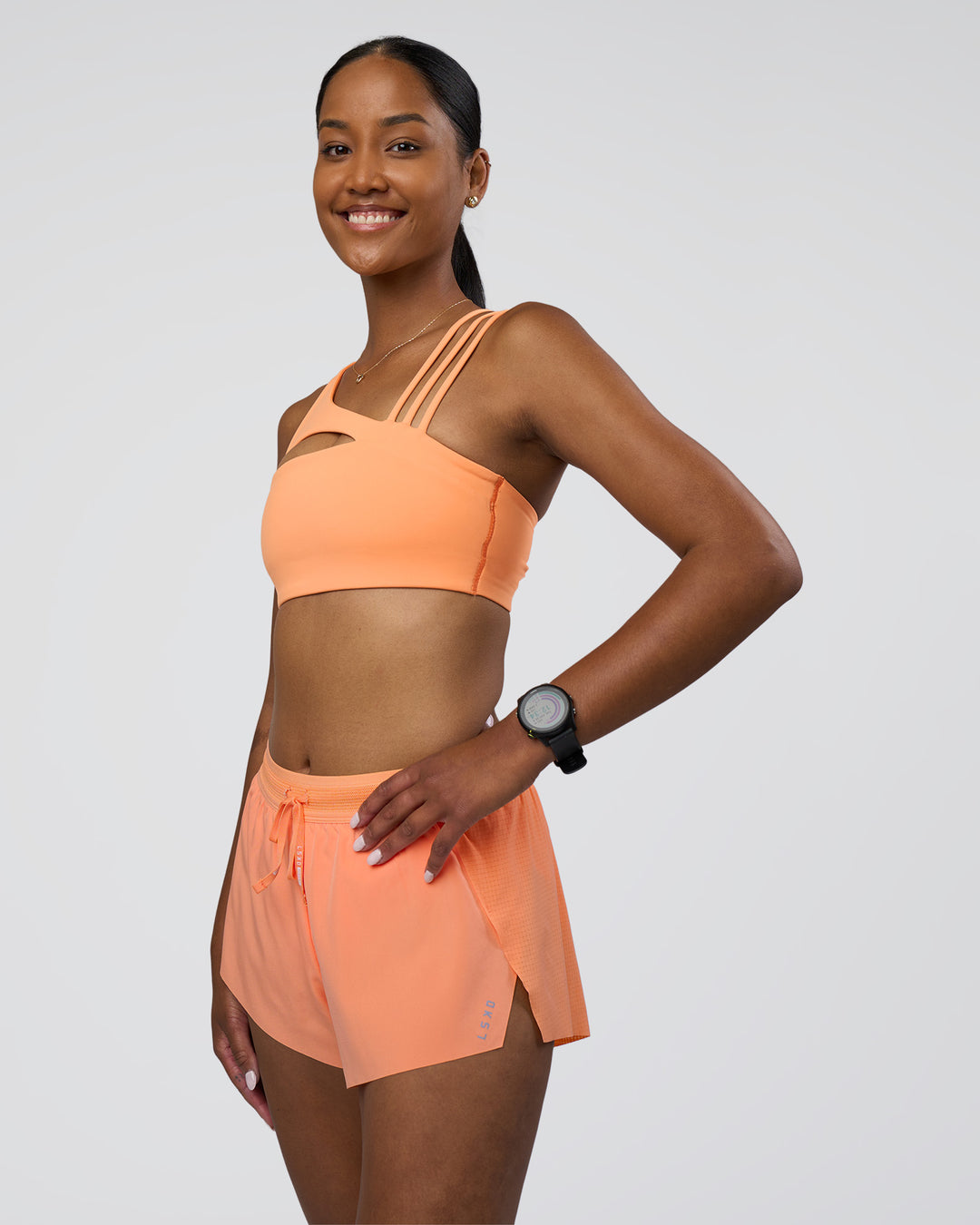 Woman wearing Galvanise Splice Sports Bra - Cantaloupe | Model:Rica | Size:S