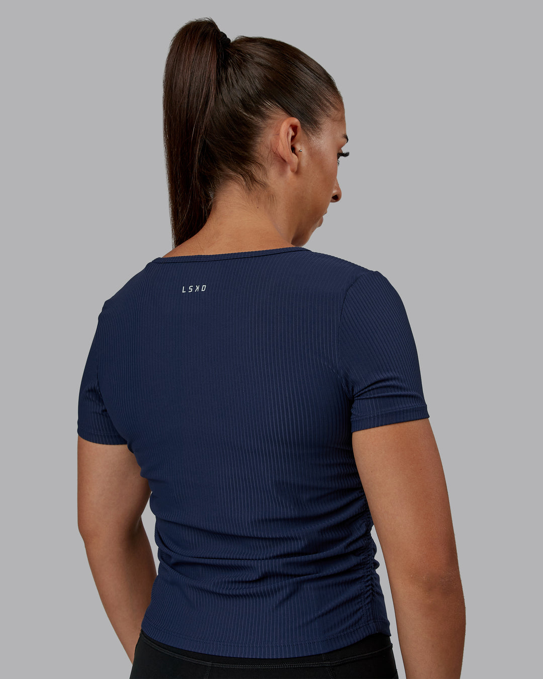 Woman wearing Ignite Ribbed Scrunch Side Cropped Tee - Future Navy | Size:S | Model:Tylah