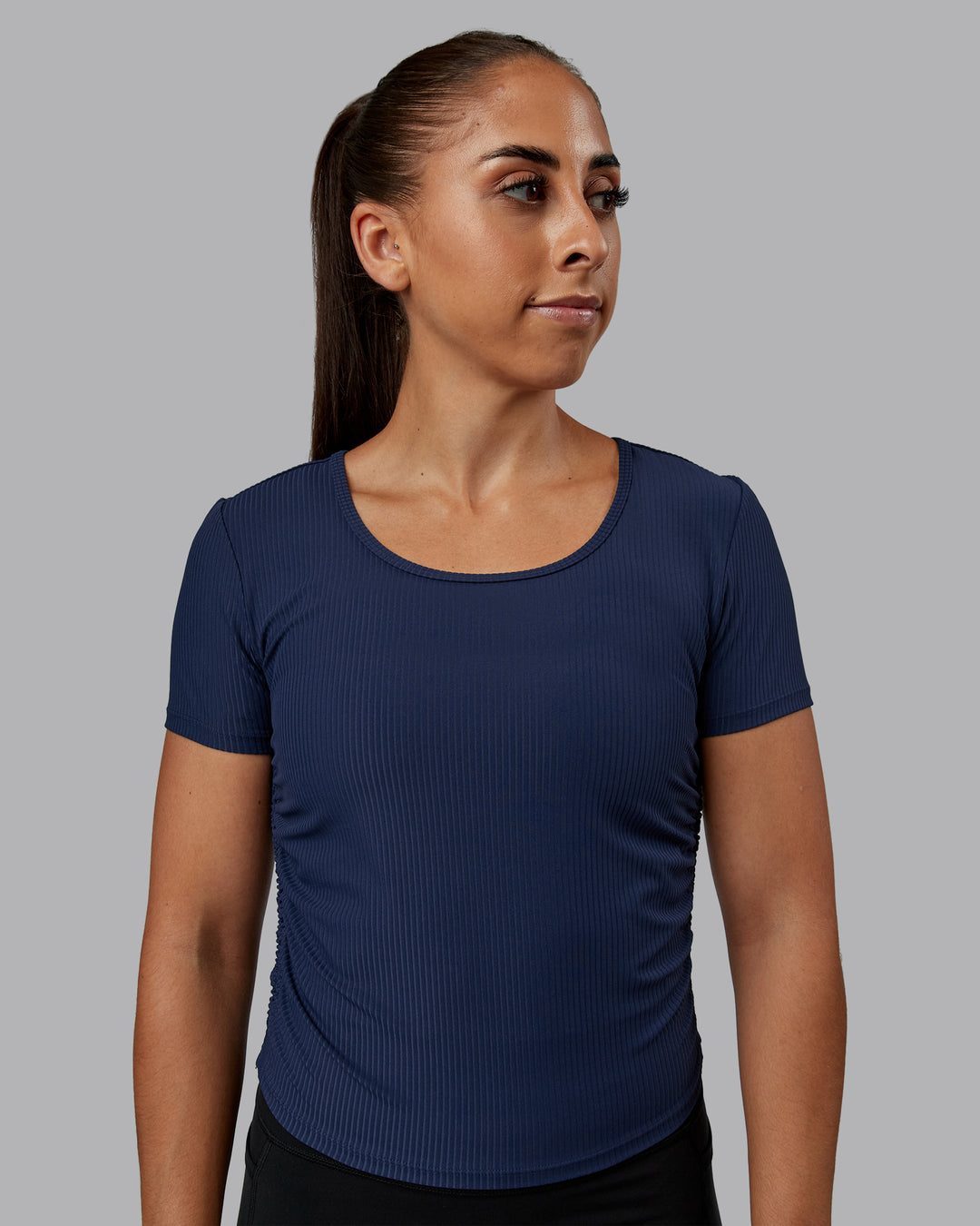 Woman wearing Ignite Ribbed Scrunch Side Cropped Tee - Future Navy | Size:S | Model:Tylah
