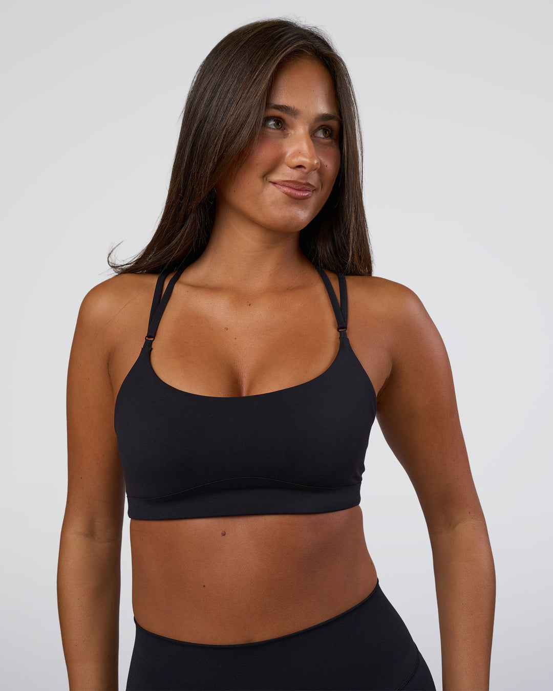 Woman wearing Luminate Sports Bra - Black | Model:Bianaca | Size:S