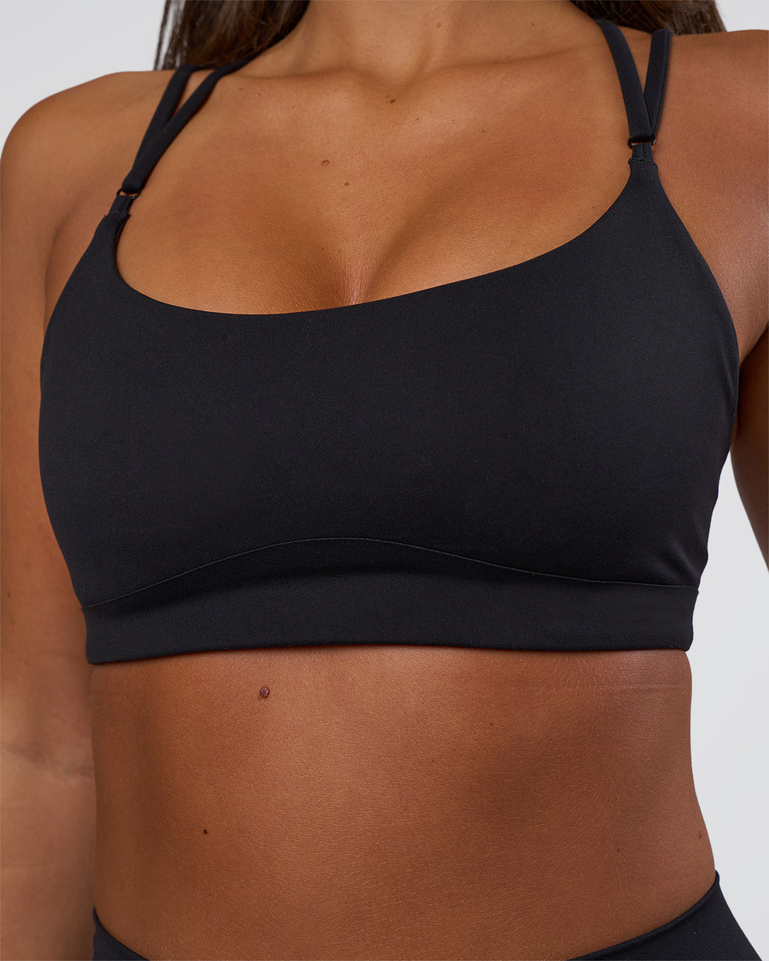 Woman wearing Luminate Sports Bra - Black | Model:Bianaca | Size:S