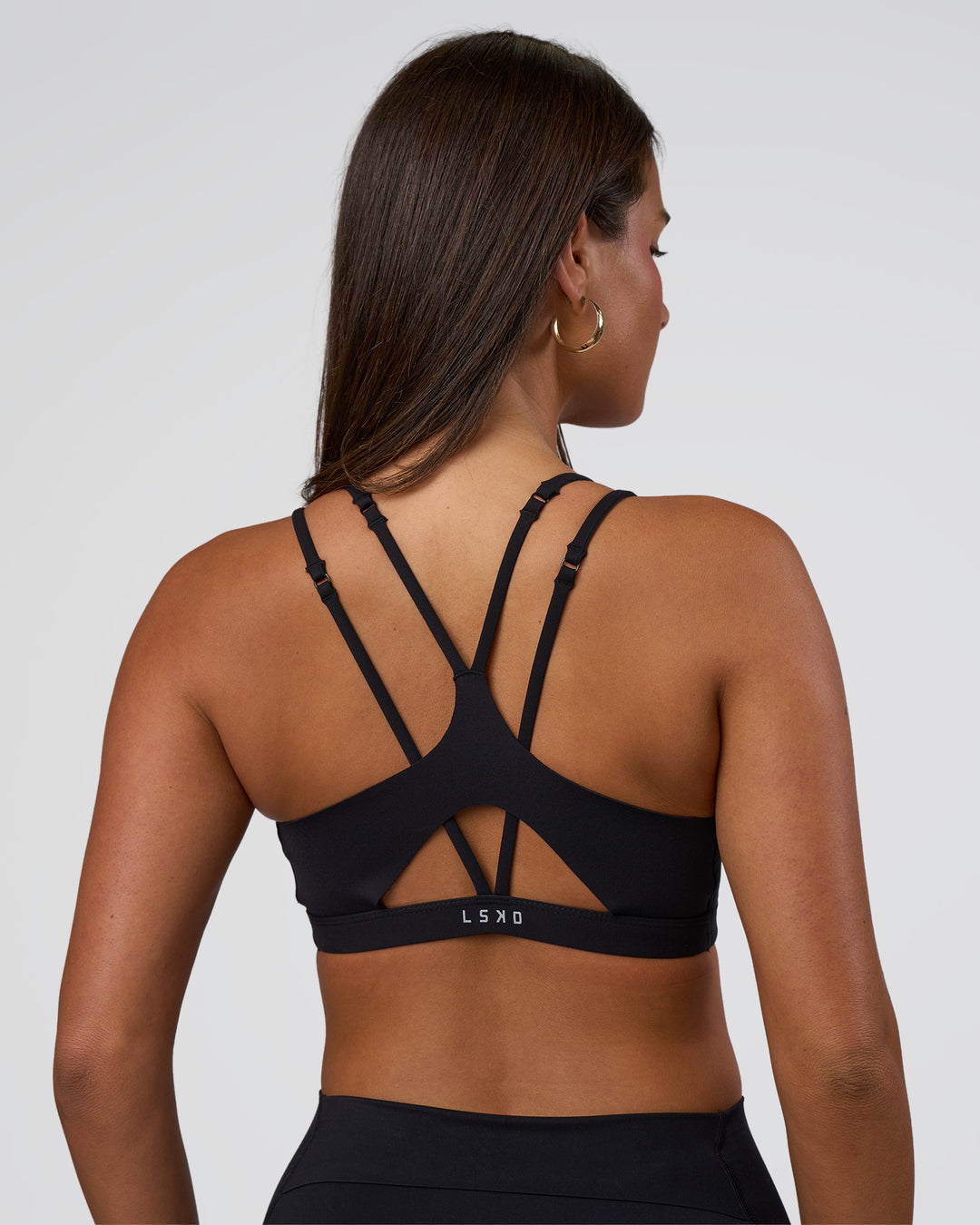 Woman wearing Luminate Sports Bra - Black | Model:Bianaca | Size:S
