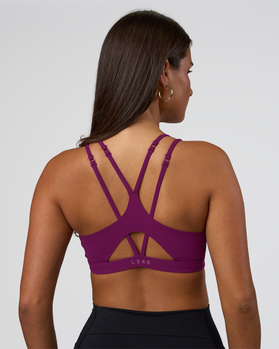 Woman wearing Luminate Sports Bra - Plum Caspia | Model:Bianca | Size:S