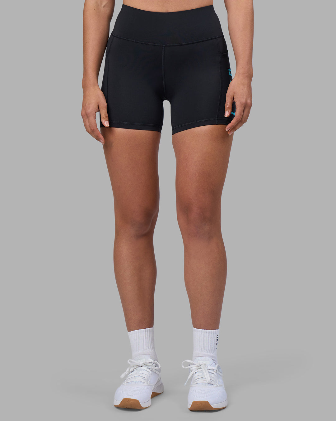 Woman wearing Rep Ultra High-Rise 4" Short Pockets - Black-Blue Atoll | Model:Sophie | Size:S