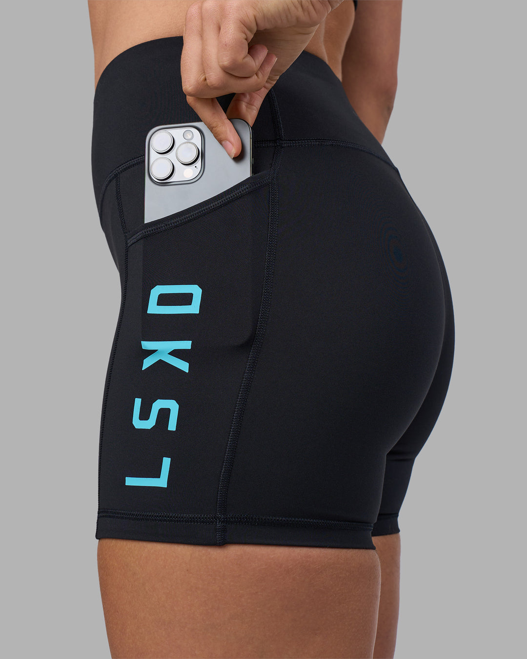 Woman wearing Rep Ultra High-Rise 4" Short Pockets - Black-Blue Atoll | Model:Sophie | Size:S