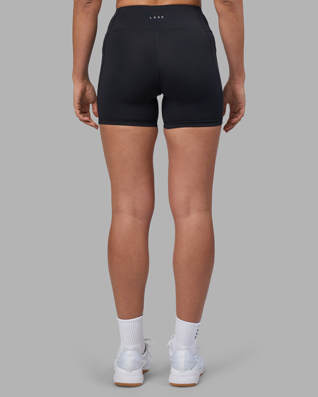 Woman wearing Rep Ultra High-Rise 4" Short Pockets - Black-Blue Atoll | Model:Sophie | Size:S