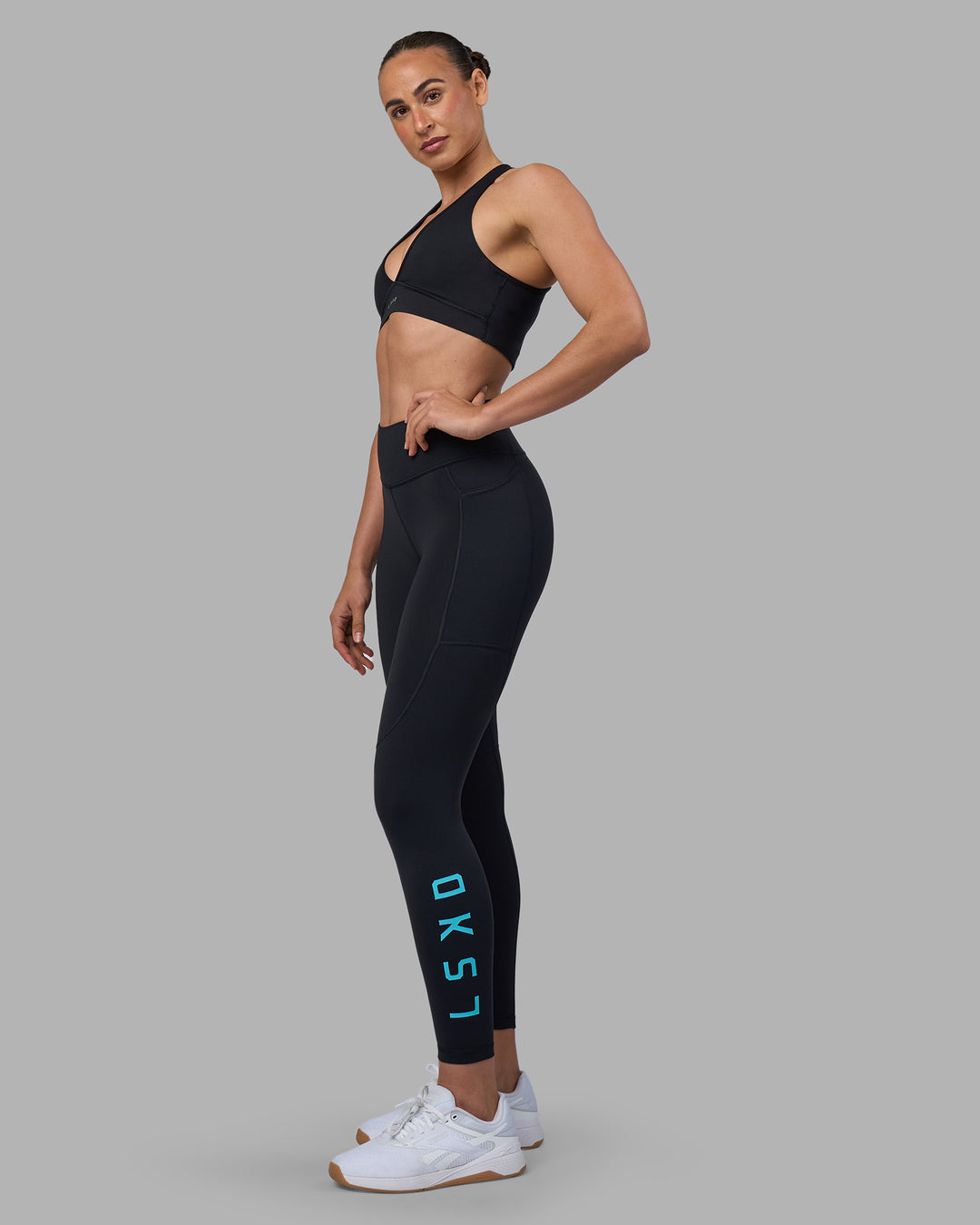 Woman wearing Rep Ultra High-Rise 7/8 Legging Pockets - Black-Blue Atoll | Model:Sophie | Size:S