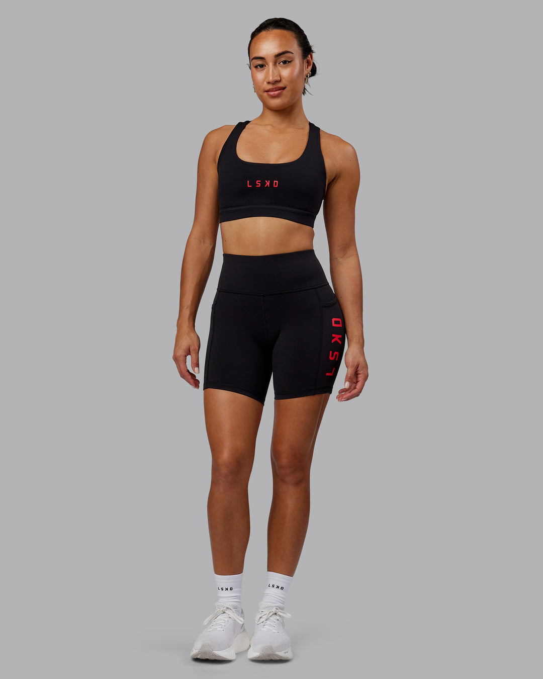 Woman wearing Rep Ultra High-Rise 6" Short Pockets - Black-Scarlet | Model:Demi | Size:S