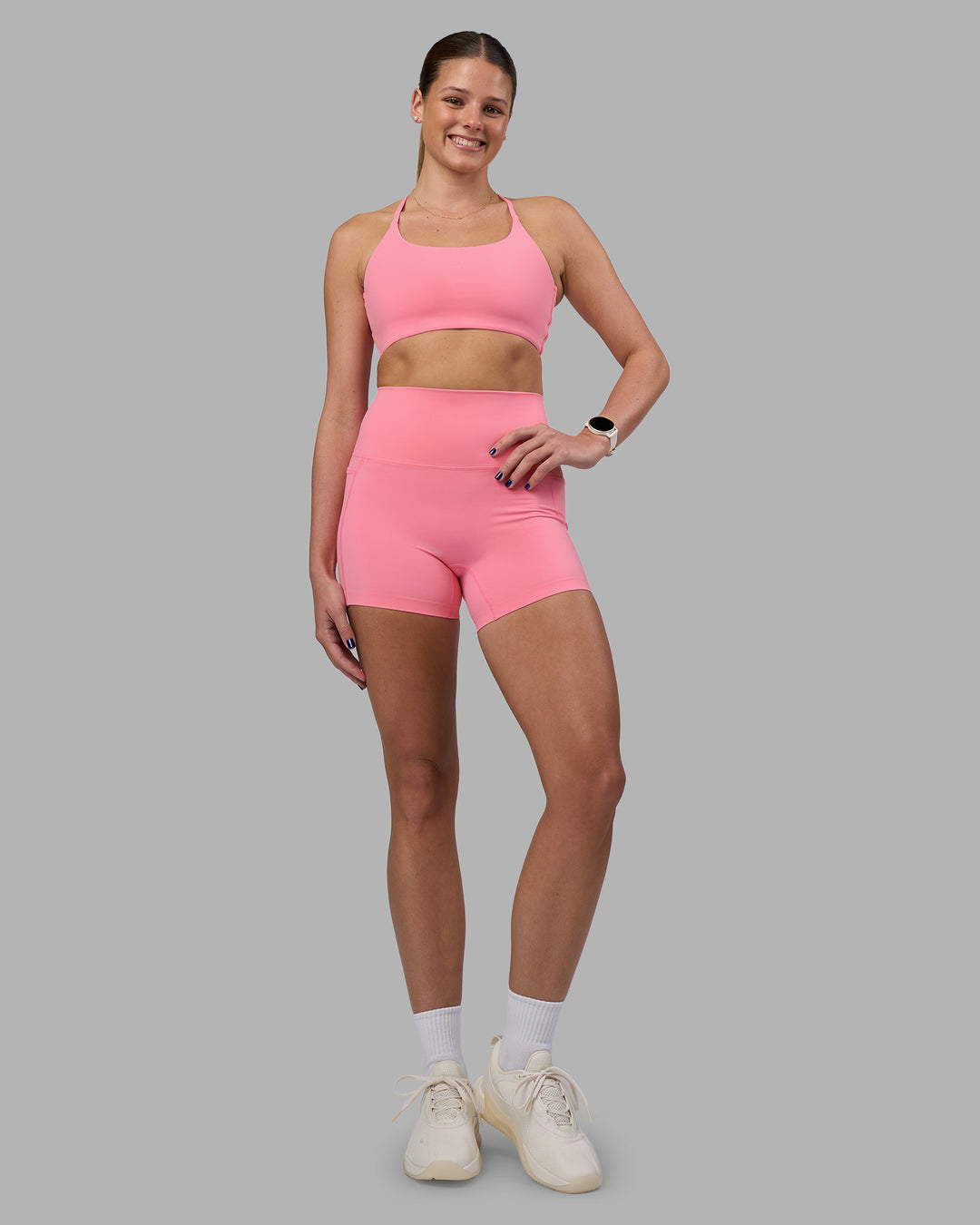 Woman wearing Twist Sports Bra - Candy Pink | Model:Phoebe | Size:S