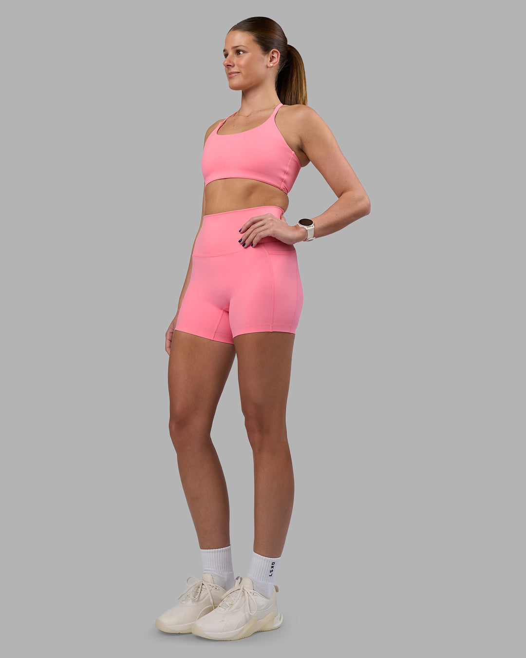 Woman wearing Twist Sports Bra - Candy Pink | Model:Phoebe | Size:S