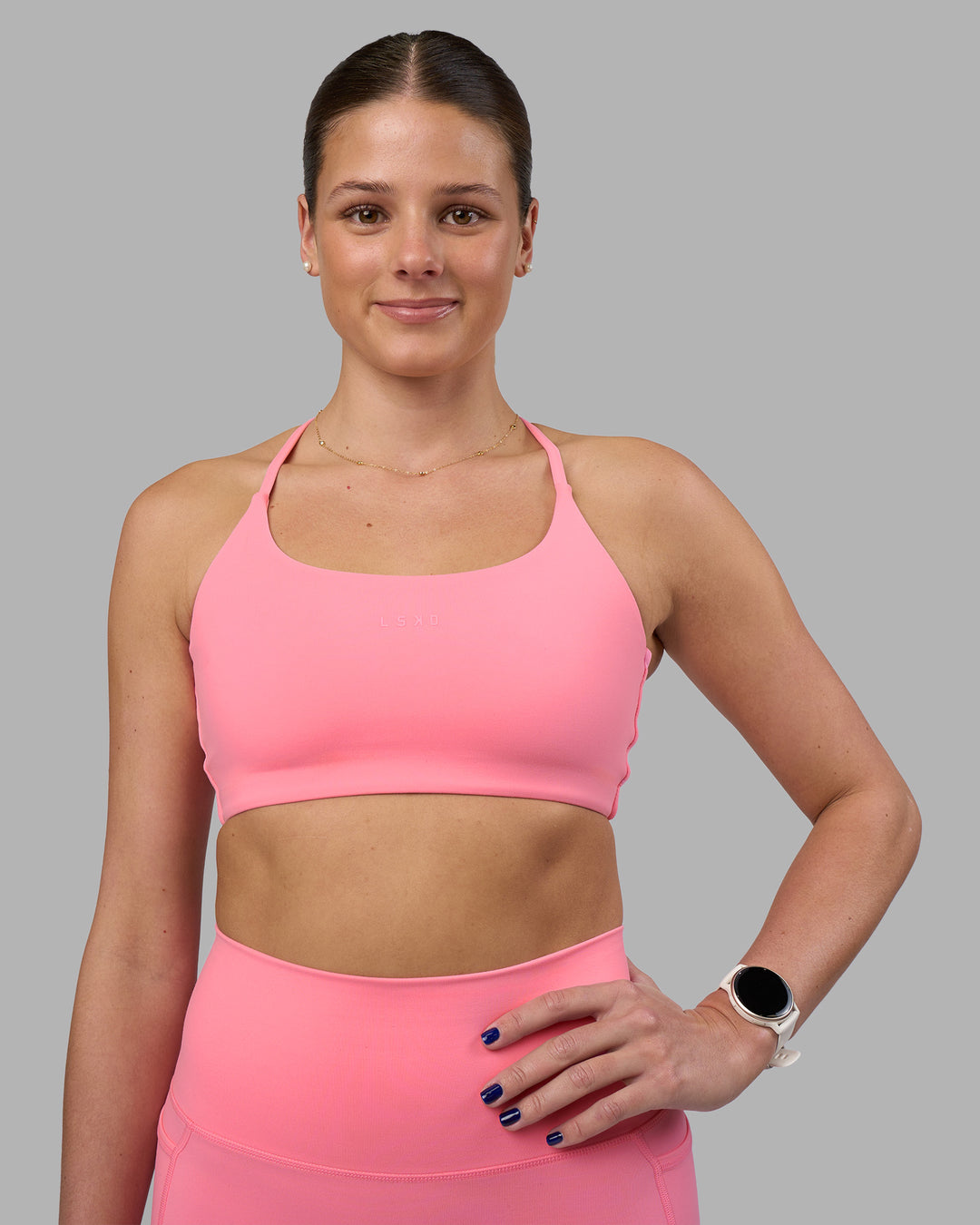 Woman wearing Twist Sports Bra - Candy Pink | Model:Phoebe | Size:S