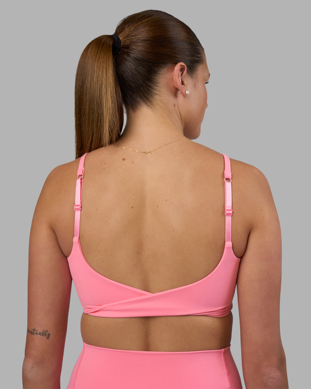 Woman wearing Twist Sports Bra - Candy Pink | Model:Phoebe | Size:S