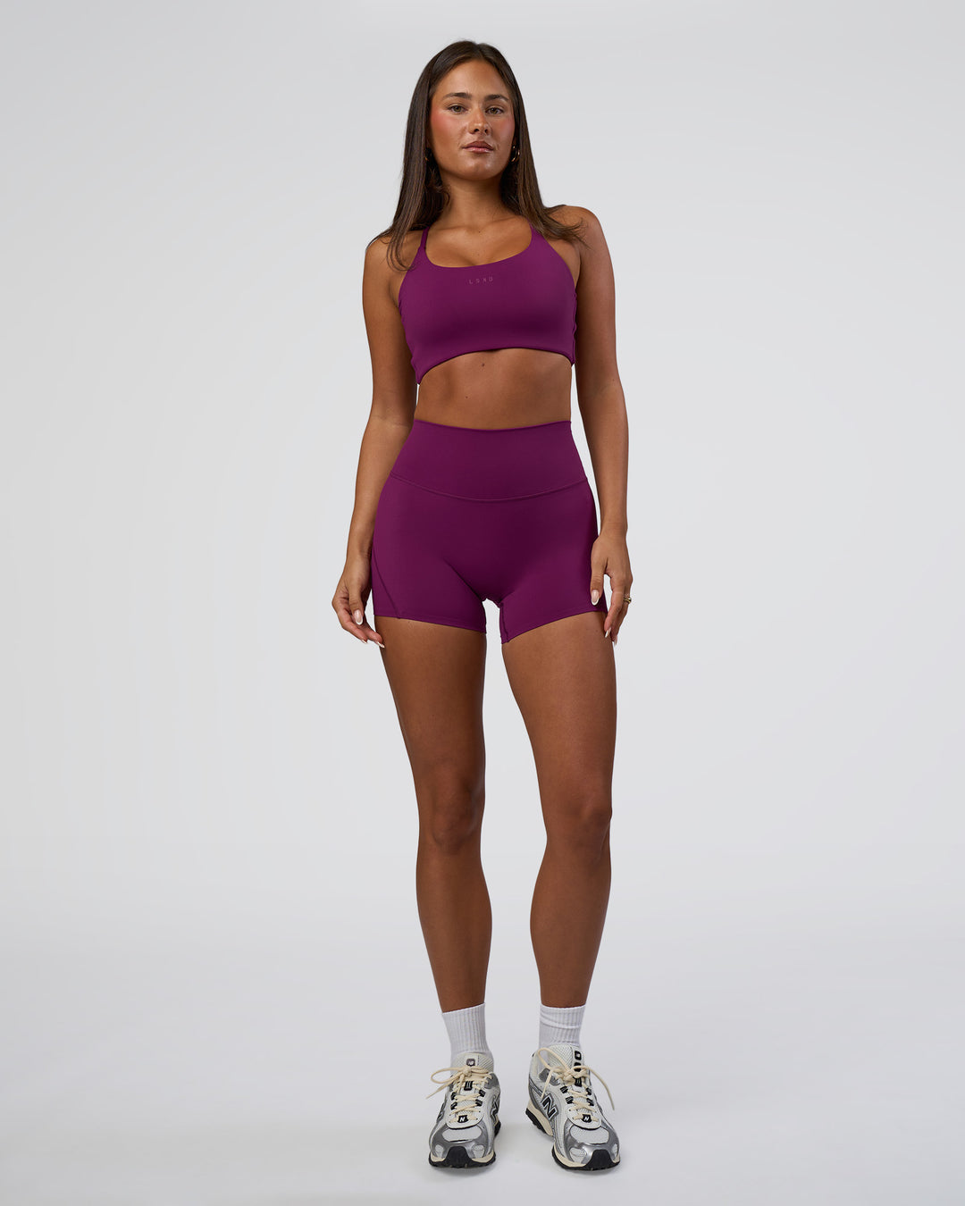 Woman wearing Twist Sports Bra - Plum Caspia | Model:Bianca | Size:S