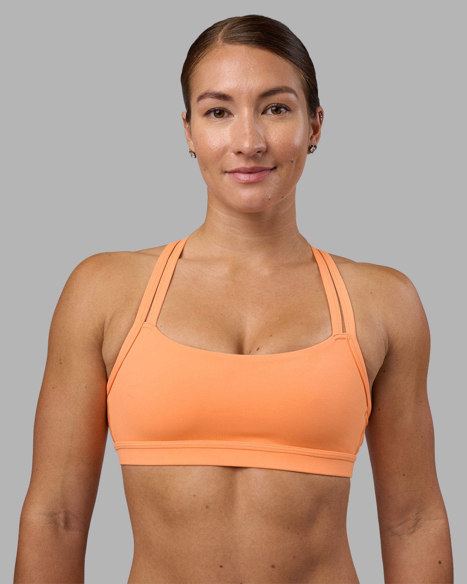 Woman wearing Velocity Sports Bra - Cantaloupe | Model:Hannah | Size:S