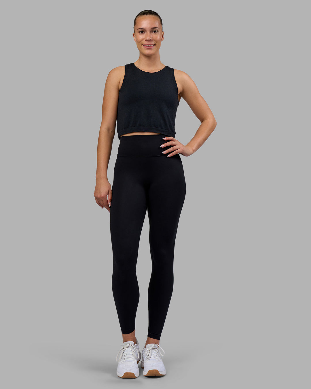 Woman wearing AeroFLX+ Seamless Skimmer Tank - Black Marl | Model:Charlize | Size:S