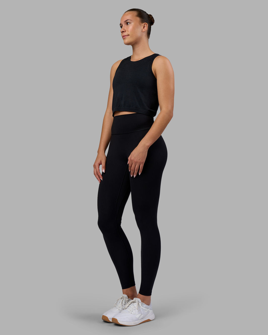 Woman wearing AeroFLX+ Seamless Skimmer Tank - Black Marl | Model:Charlize | Size:S