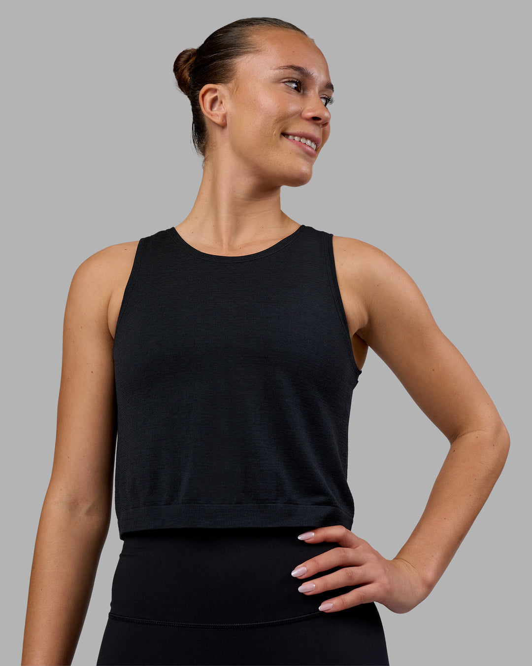 Woman wearing AeroFLX+ Seamless Skimmer Tank - Black Marl | Model:Charlize | Size:S