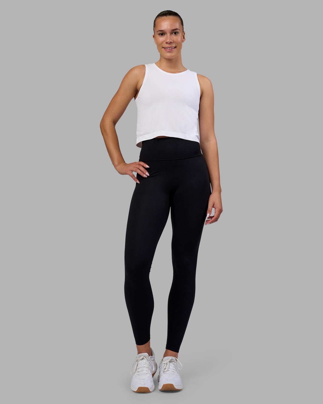 Woman wearing AeroFLX+ Seamless Skimmer Tank - White/White | Model:Charlize | Size:S