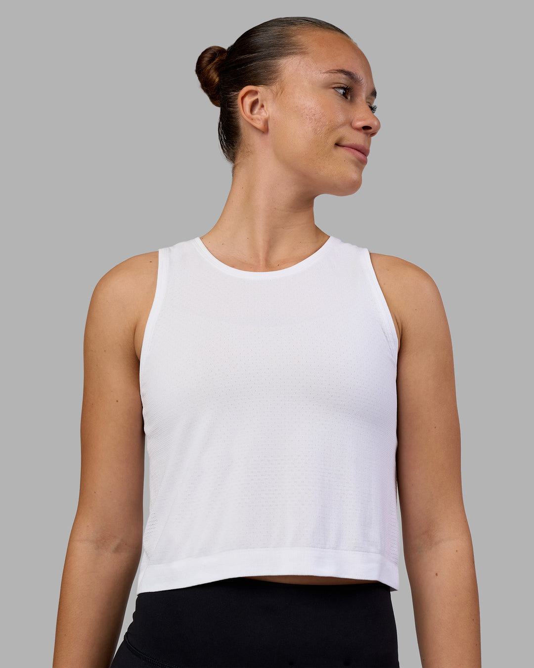 Woman wearing AeroFLX+ Seamless Skimmer Tank - White/White | Model:Charlize | Size:S