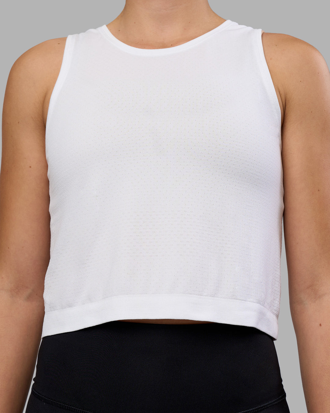 Woman wearing AeroFLX+ Seamless Skimmer Tank - White/White | Model:Charlize | Size:S