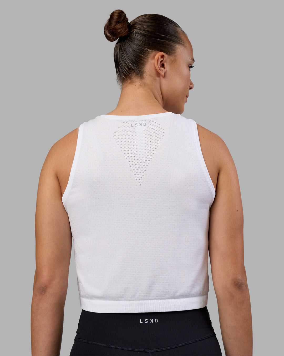 Woman wearing AeroFLX+ Seamless Skimmer Tank - White/White | Model:Charlize | Size:S