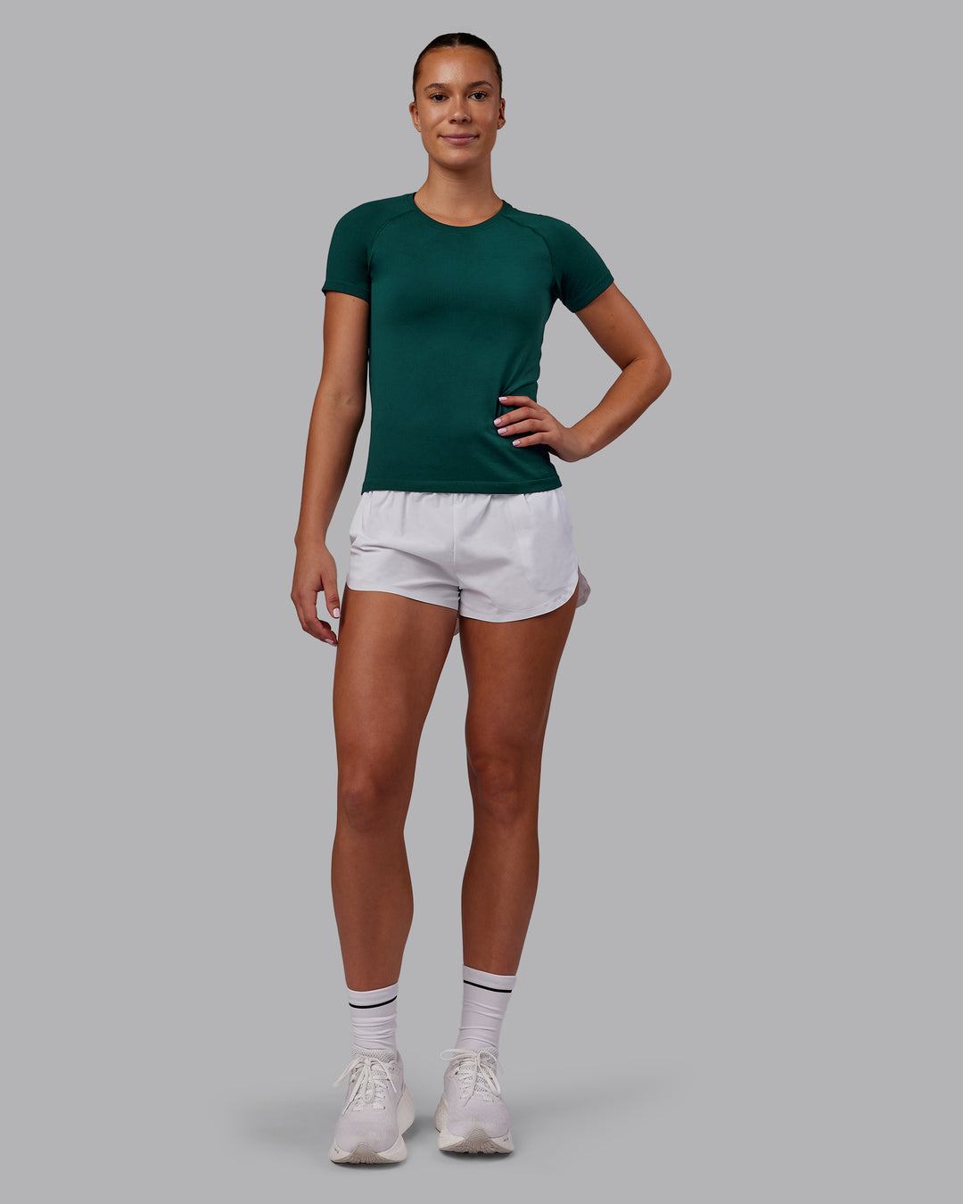 Woman wearing AeroFLX+ Seamless Tee - Dark Moss Marl | Model:Charlize | Size:S