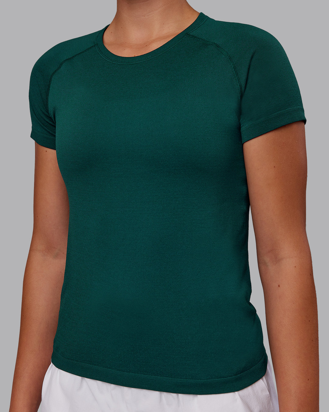Woman wearing AeroFLX+ Seamless Tee - Dark Moss Marl | Model:Charlize | Size:S